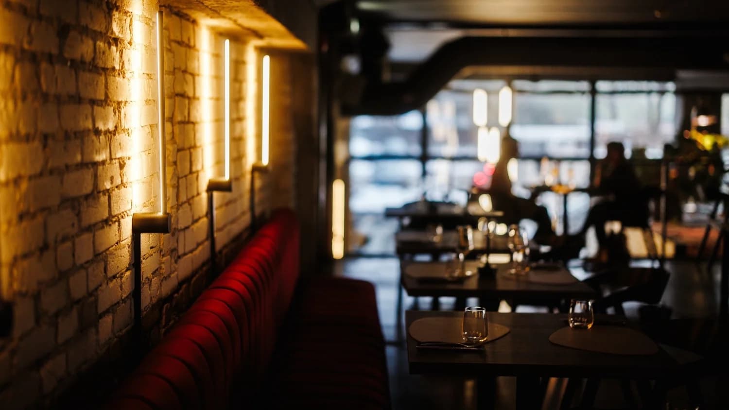 Puente restaurant interior — warm lighting, brick walls, modern dining